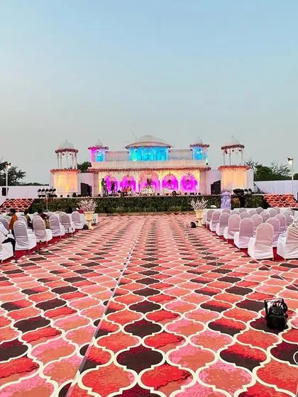 I build dream wedding stages, like this expansive 'Rajwada' setup. The design features a pristine white palace facade, complete with domes and archways, creating a timeless and elegant backdrop for the main ceremony.
