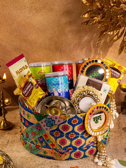 A unique, fabric-covered basket hamper for Diwali. I styled it with traditional brassware and marigolds to emphasize its ethnic charm and handcrafted feel.