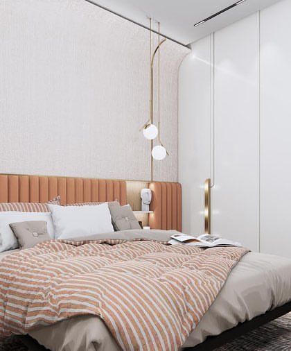 This angle shows the brass detailing and textured wall panels that add a layer of sophistication and warmth to the simple, modern bedroom design.
