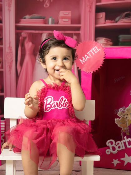 A shy, sweet smile from a little girl during her Barbie photoshoot. I work to make kids feel comfortable so their true personality shines through.