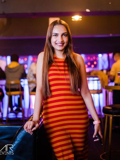 A guest posing in a striped dress.