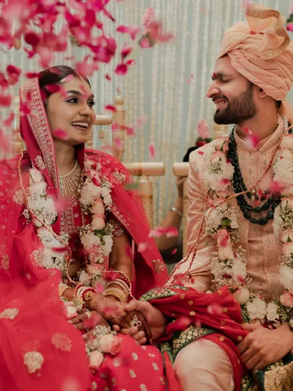 We love it when couples make their own rules. This bride and groom were best friends who decided to get ready together, sharing smiles and laughter as flower petals showered them during the ceremony. A perfect wedding isn't about perfection, it's about a heart that is full.