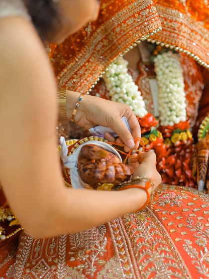 A close-up of a ritual during the wedding ceremony, highlighting the intricate details and traditions.