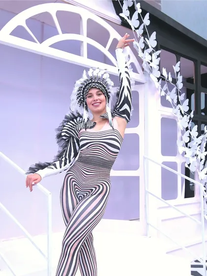 A performer in a stunning black-and-white optical illusion costume, embodying the chic and artistic 'Line Art Carnival' theme.
