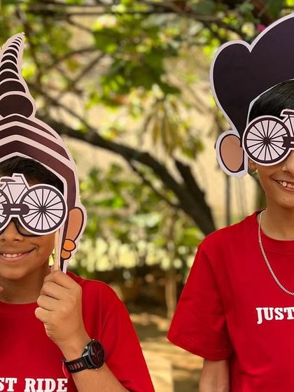 Fun for all ages! Our younger supporters enjoying the photo props while wearing our red 'Just Ride' T-shirts.