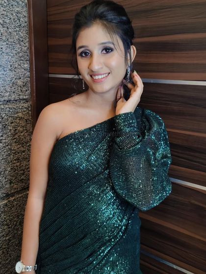 Another shot of Swathi's gorgeous party look. The one-shoulder glittery dress is perfectly complemented by the radiant makeup and effortless hairstyle.