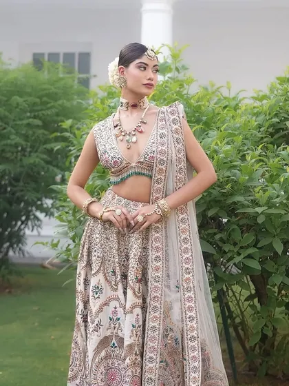 A full-length shot of the "Laila" lehenga in a garden setting. The styling is fresh and perfect for a daytime wedding.