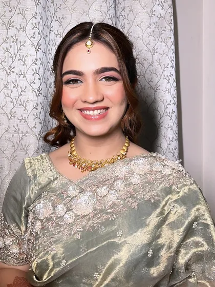A beautiful smile from my happy client. Her makeup is soft, glowing, and perfect for an engagement or reception, paired with a lovely sage green saree.