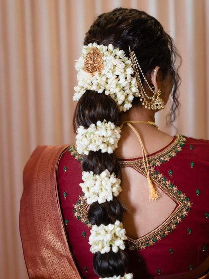 A detailed view of the beautiful jasmine braid, a hallmark of traditional South Indian bridal hairstyles.