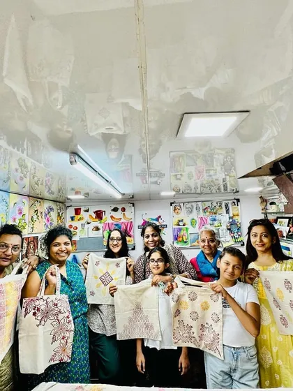 The best part of our workshops is the community. Here's a wonderful group from our World Art Day session, proudly showing off the unique tote bags they designed and printed themselves.