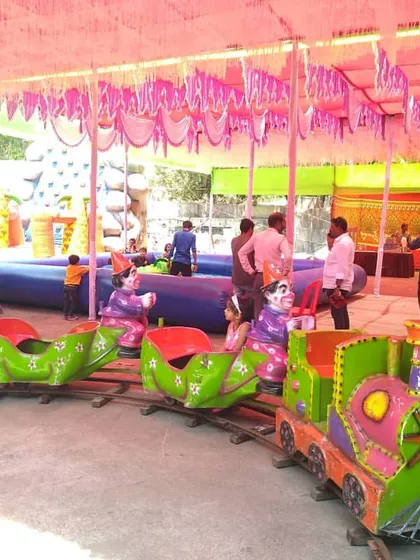 A view of the mini train set up under a tent at a carnival-style event. It's a reliable attraction that keeps young children entertained.