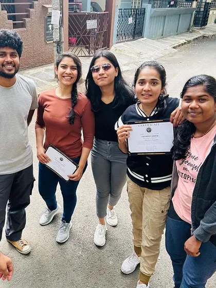 A group of graduates proudly holding their certificates. They are now certified riders, ready for new adventures.