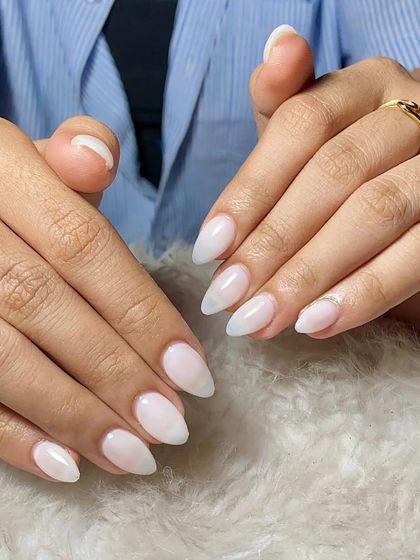 A soft and natural look. These almond-shaped extensions feature a milky white ombre effect, giving the nails a subtle and elegant gradient.