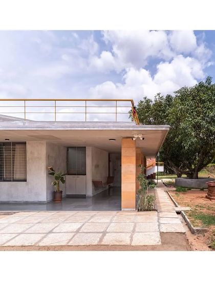 The 'Jagli katte' concept creates a continuous semi-open space around the house. This design allows the interior spaces to open up to the surrounding greenery, from flowering plants to the productive mango orchard.