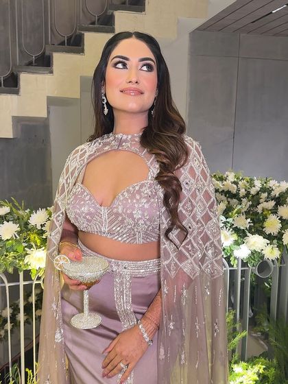 A candid moment enjoying the festivities. The makeup remains flawless, and the highlighter catches the light beautifully.