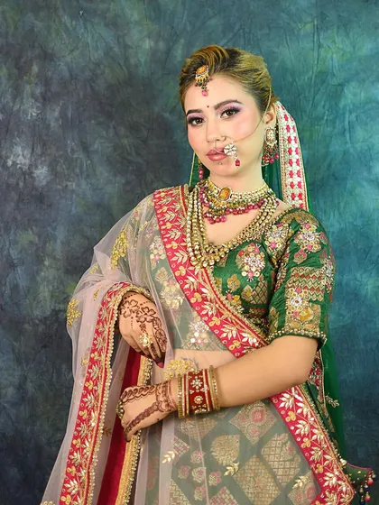 A classic three-quarter shot of the bridal look, highlighting the beautiful embroidery and the layers of jewelry.