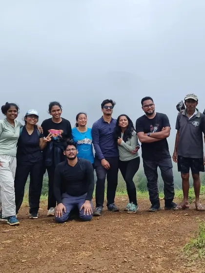 A small group enjoying the misty weather on a hilltop. Our treks are suitable for all group sizes, from solo travelers to close-knit friends.