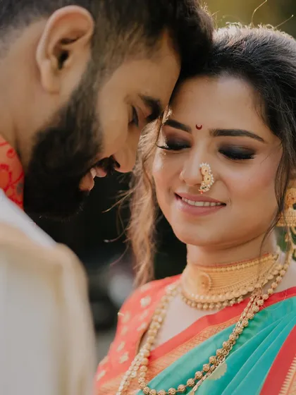 A close-up of the happy couple. The bride's makeup is soft and romantic, with beautifully blended eyeshadow and a smile that lights up the frame.