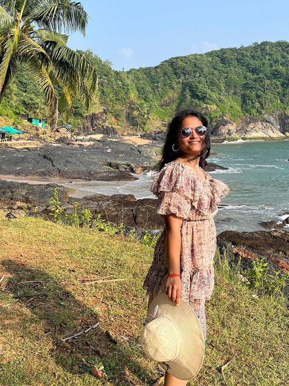 A happy traveler enjoying the sunny beach weather in Gokarna.