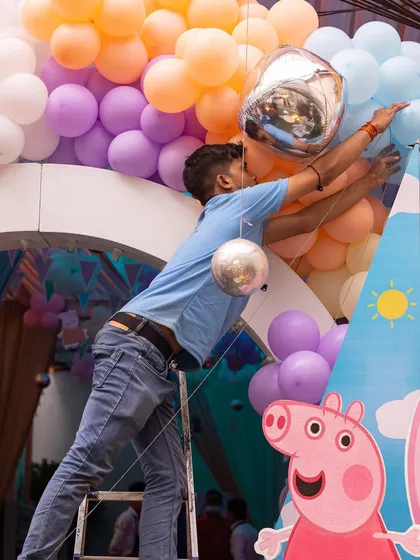 Up on the ladder to get everything just right. Our team is dedicated to making sure every balloon and banner is perfectly placed.
