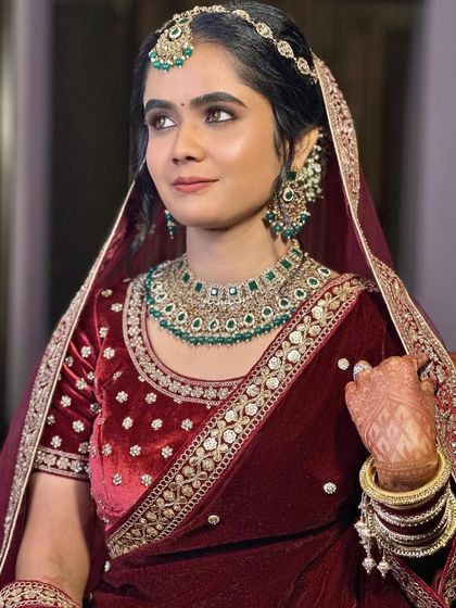 A side profile showcasing the elegant hairstyle and the way the makeup complements her features and jewelry.