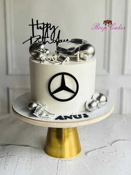Luxury meets celebration. A sleek Mercedes-themed cake for a 15th birthday, complete with edible dollar bills and silver glam.