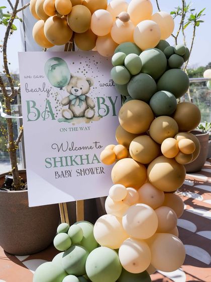 A close-up of the welcome sign, featuring the 'We can bearly wait' tagline and a sweet teddy bear graphic, perfectly matching the event's theme and color scheme.
