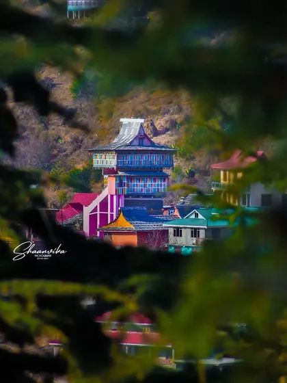 Another perspective of the Dharech Temple seen through the trees. This framing technique creates a natural, intimate view, as if you are stumbling upon a hidden gem.