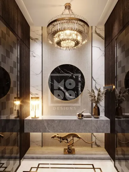 A foyer isn't just an entryway; it's the prologue to your home's story. Here, a dramatic chandelier, marble console, and curated decor set the tone for the luxury that lies beyond.