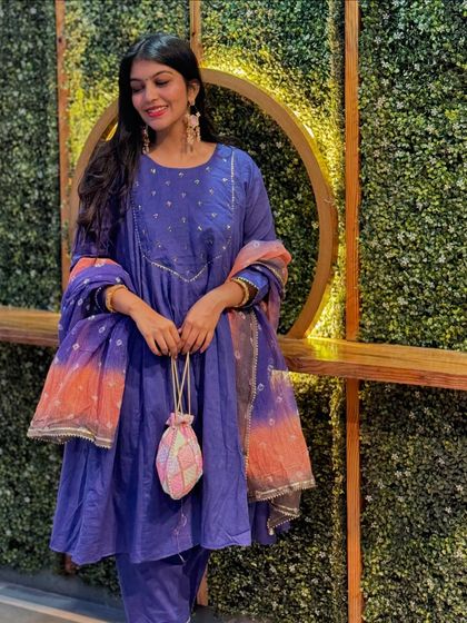 A vibrant blue anarkali paired with a colorful tie-dye dupatta. This is a fun and playful outfit, perfect for a mehendi or a festive brunch.