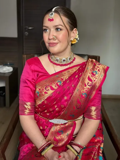 A side profile showing the traditional Indian jewelry and the soft, glowing makeup. This is how you do fusion beauty.