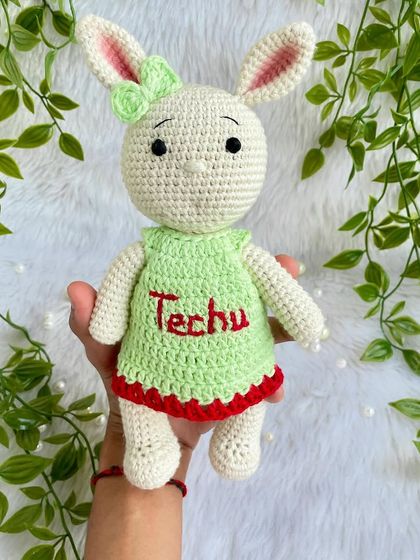 Another one of my popular bunny designs, this time in a lovely green dress with red trim, personalized with the name "Techu". I never get tired of making these sweet friends.