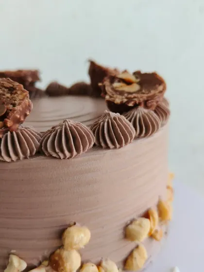 A close-up of the Ferrero Rocher and hazelnut toppings on this indulgent cake.
