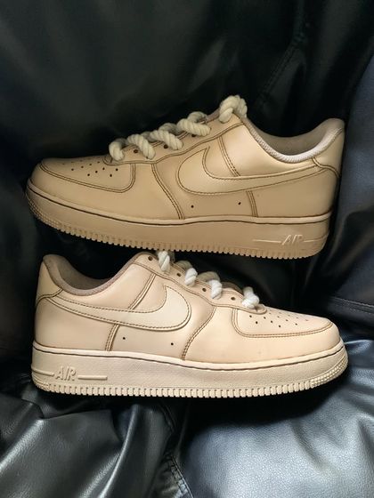 A pair shot of the coffee custom sneakers on a black background.