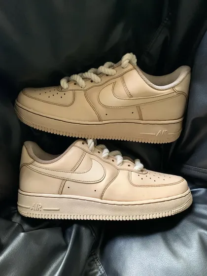 A pair shot of the coffee custom sneakers on a black background.