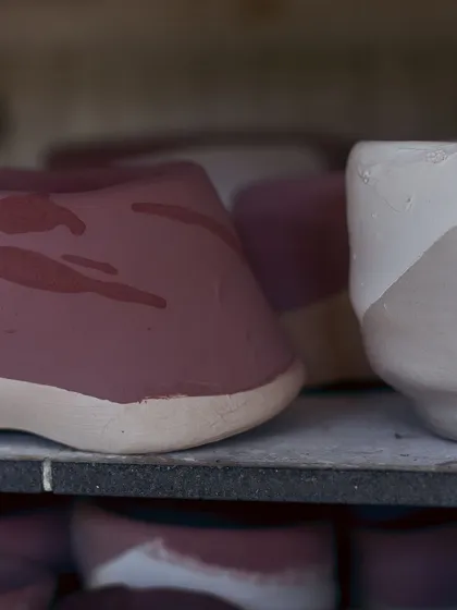 Pieces waiting on the kiln shelf, painted and ready to be fired. The anticipation of seeing the final result is part of the magic.