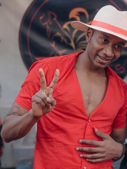 A cosplayer dressed as Monkey D. Luffy from One Piece gives a peace sign to the camera. The photo captures the cheerful and adventurous spirit of the character.