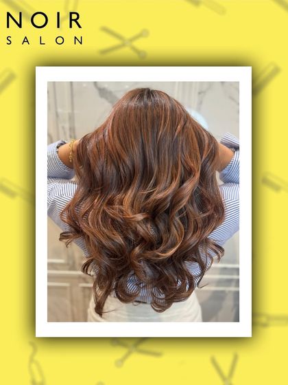 This rich auburn-brown color is full of warmth and dimension. Styled in voluminous waves, the hair looks incredibly healthy, shiny, and full of life.