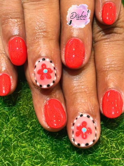 A classic red base with the gentle charm of flowers. I hand-painted these cute floral designs on accent nails for a pop of detail.