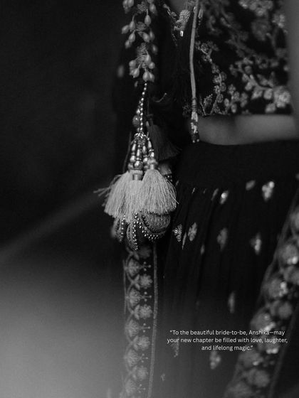 A detailed black and white shot focusing on the beautiful tassels of the bride's lehenga. I believe in capturing these small, artistic details that complete the story.