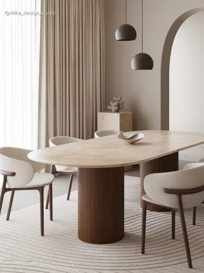 This dining setup is a perfect example of my love for Japandi-inspired design. The organic shape of the marble tabletop, paired with a warm, fluted wooden base and soft, curved chairs, creates a feeling of calm sophistication. It’s minimalism that feels warm and inviting.