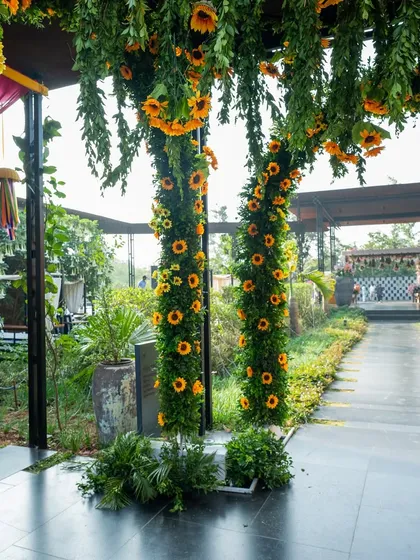 The pathway to the Haldi ceremony, flanked by pillars of sunflowers, creating a grand and sunny welcome.