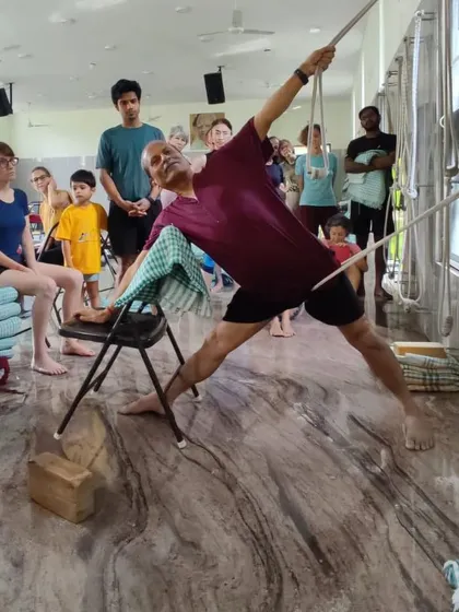 Here, I demonstrate Utthita Trikonasana (Triangle Pose) using a chair and ropes. This showcases the Iyengar method's use of props to achieve precise alignment and a deeper understanding of the asana's mechanics.