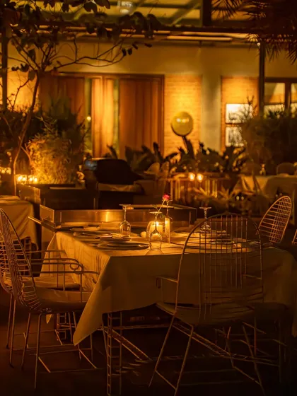 Photography isn't just about the food, it's about the feeling. This shot captures the warm, intimate ambiance of a fine-dining restaurant at night, helping customers envision their own special evening out.