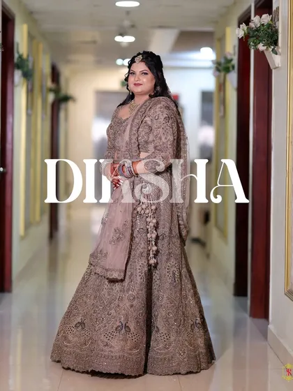 A full-length portrait of the bride in her elegant engagement lehenga, with her name stylishly written.