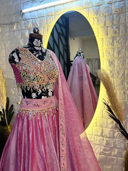 This mirror work lehenga looks stunning from every angle. The reflection in the mirror shows the beautiful drape of the dupatta.