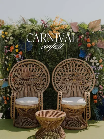 'Carnival Confetti' - a fun and festive Mehendi seating area with rattan peacock chairs and a vibrant green and floral backdrop.