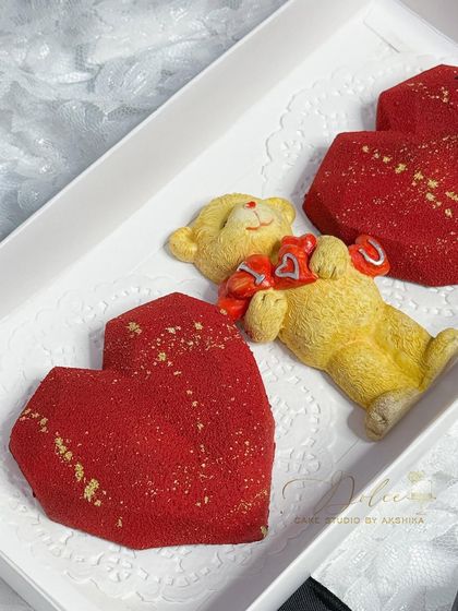 A sweet and simple Valentine's gift box. This one contains two geometric heart cakesicles with a red velvet texture and a cute, non-edible teddy bear holding 'I Love You' hearts.