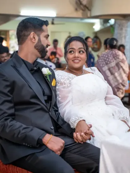 A candid glance shared between the bride and groom during their Catholic wedding ceremony. These small, unscripted interactions are what make your wedding story unique.