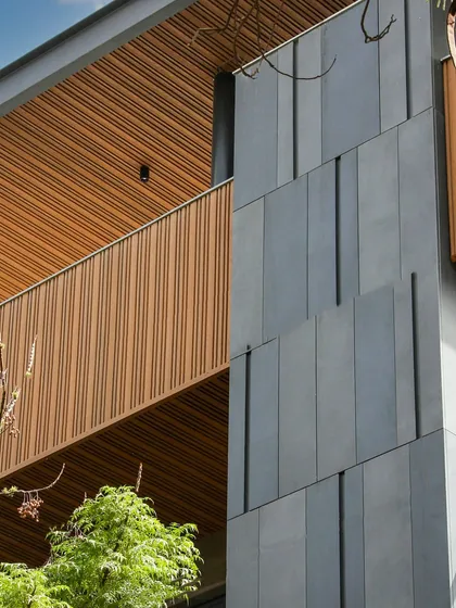 Another detail of the Poorvi Marg facade, showcasing the clean lines and the rich texture of the materials. The design is a perfect blend of sustainability and style.
